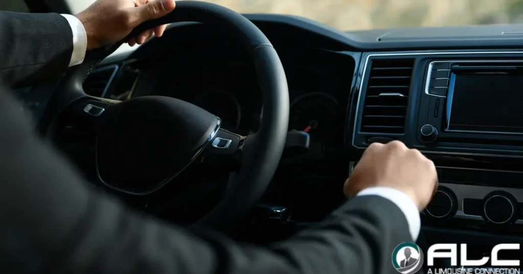 Chauffeur driving car, hands on steering wheel. | ALC